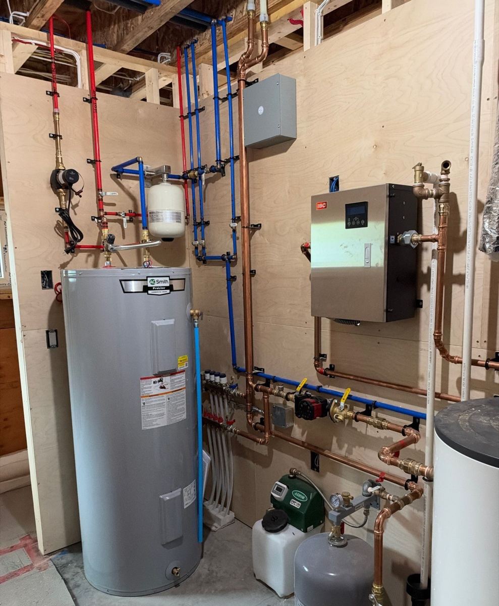 Mechanical room with electric boiler, indirect tank, radiant manifold and copper and PEX distribution